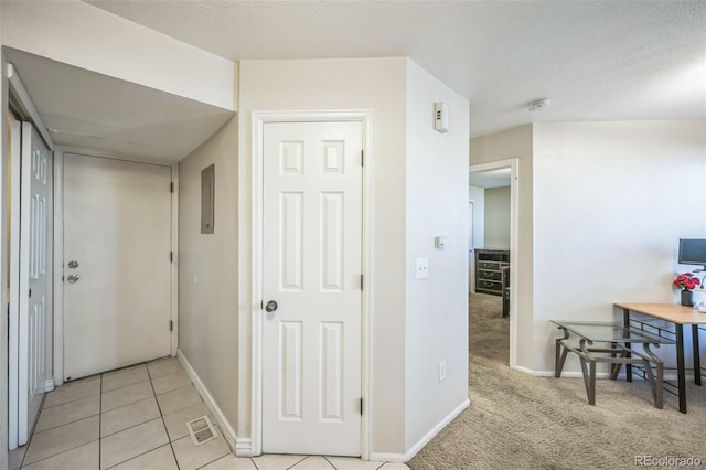 hallway with light colored carpet and baseboards