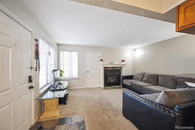 living room with carpet, a premium fireplace, and baseboards