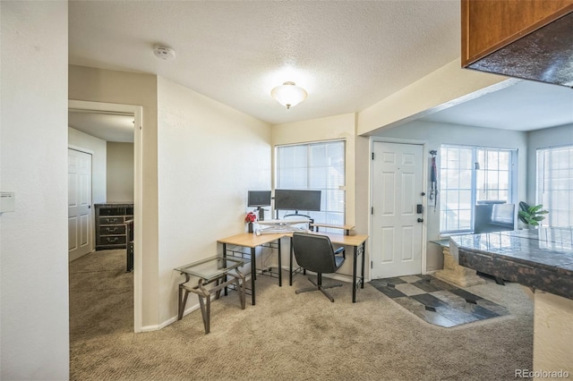 office area featuring carpet flooring and a textured ceiling