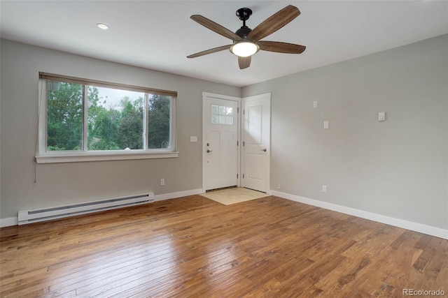 9743 W 67th Pl, Arvada, CO 80004 - entrance foyer featuring a baseboard radiator, plenty of natural light, a ceiling fan, and wood-type flooring