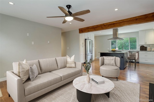 9743 W 67th Pl, Arvada, CO 80004 - living room featuring recessed lighting, light wood finished floors, a ceiling fan, beamed ceiling, and baseboards