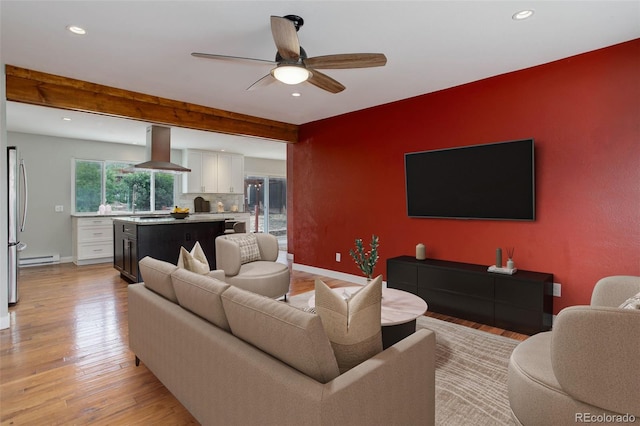9743 W 67th Pl, Arvada, CO 80004 - living room featuring an accent wall, light wood-style floors, ceiling fan, recessed lighting, and baseboards