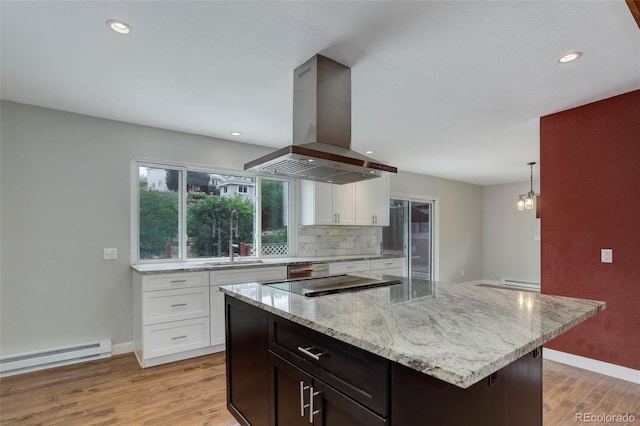 9743 W 67th Pl, Arvada, CO 80004 - kitchen with island range hood, a baseboard radiator, light wood finished floors, baseboards, and recessed lighting