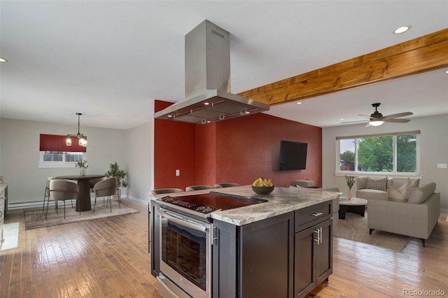 9743 W 67th Pl, Arvada, CO 80004 - kitchen with electric range, island range hood, light wood-style floors, light countertops, and recessed lighting