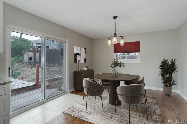 9743 W 67th Pl, Arvada, CO 80004 - dining area featuring baseboards and light wood-style flooring