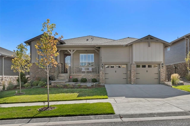 21972 E Allenspark Dr, Aurora, CO 80016 - view of front facade featuring stone siding, driveway, a front yard, and a porch