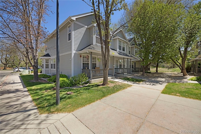 1115 W Swallow Rd Unit 20, Fort Collins, CO 80526 - view of front of property featuring covered porch, a front lawn, and concrete driveway