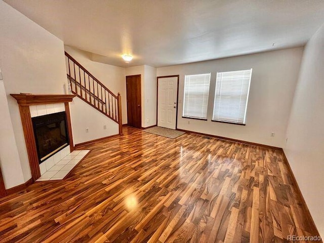 1115 W Swallow Rd Unit 20, Fort Collins, CO 80526 - unfurnished living room with wood finished floors, stairs, and a fireplace