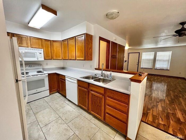1115 W Swallow Rd Unit 20, Fort Collins, CO 80526 - kitchen with white appliances, brown cabinetry, ceiling fan, and light countertops
