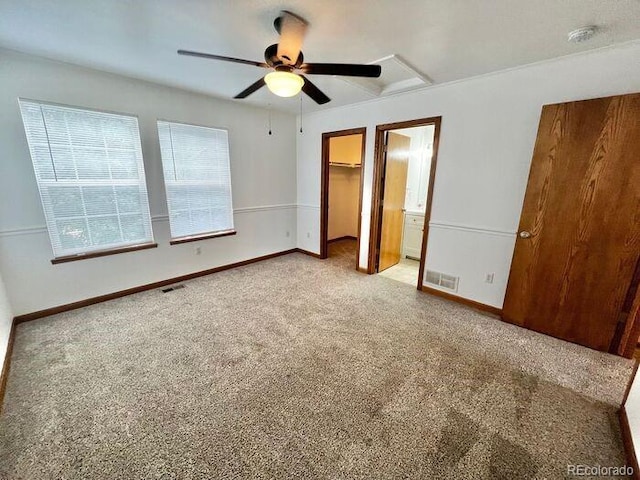 1115 W Swallow Rd Unit 20, Fort Collins, CO 80526 - unfurnished bedroom featuring carpet, a spacious closet, a ceiling fan, and attic access