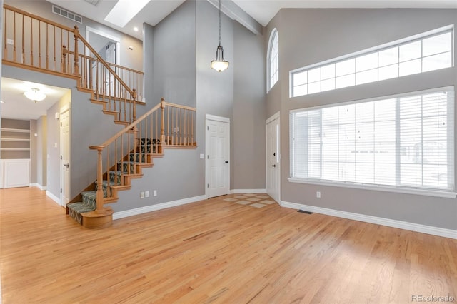 foyer with a towering ceiling and hardwood / wood-style floors