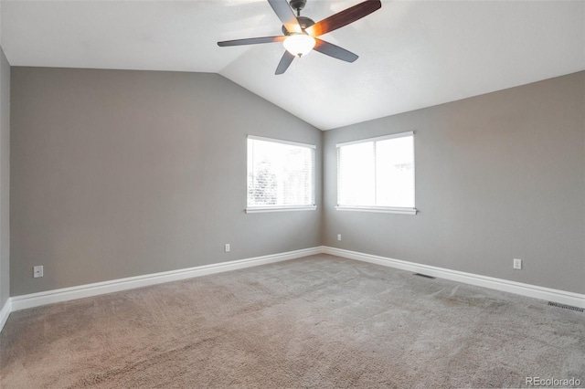 carpeted empty room with ceiling fan and lofted ceiling