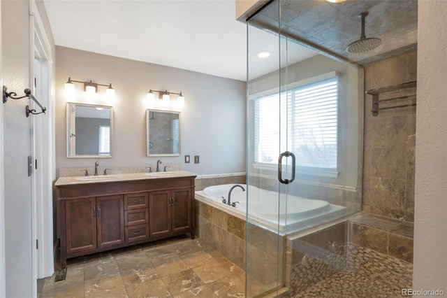 bathroom featuring shower with separate bathtub and vanity