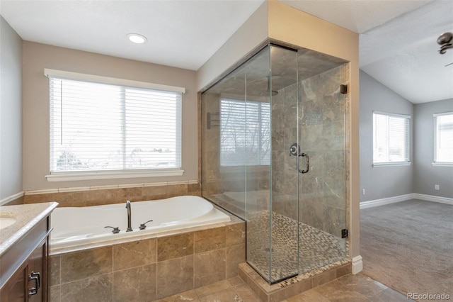 bathroom with vanity, vaulted ceiling, tile patterned floors, and plus walk in shower