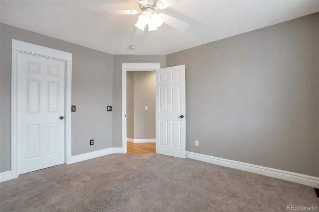 unfurnished bedroom featuring ceiling fan and light carpet