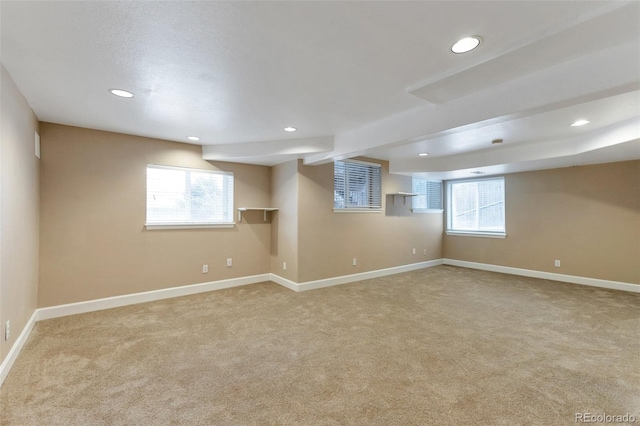 basement featuring light colored carpet