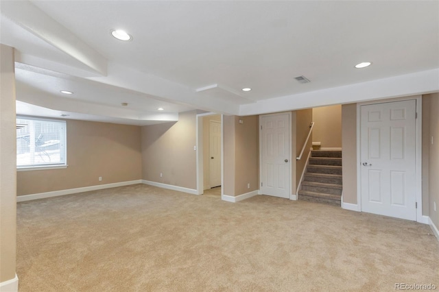 basement featuring light carpet