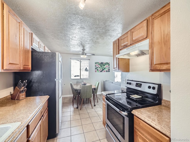 kitchen with ceiling fan, sink, a textured ceiling, light tile patterned floors, and appliances with stainless steel finishes