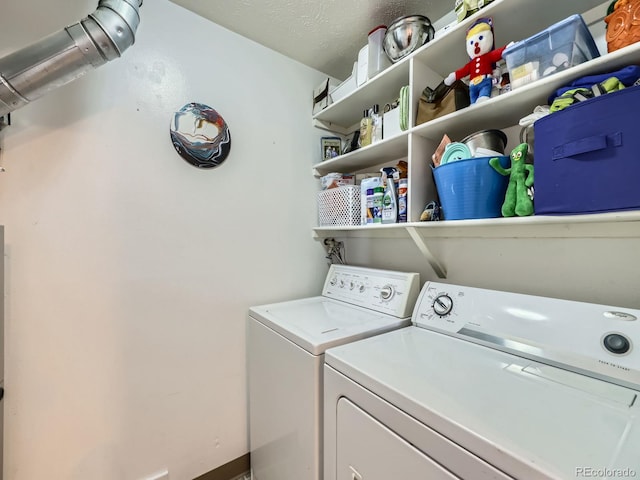 laundry area featuring washing machine and dryer and a textured ceiling