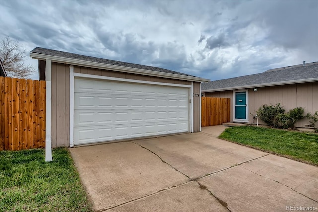 view of front facade featuring an outbuilding, a garage, and a front lawn