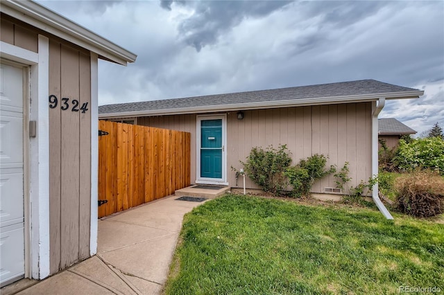 doorway to property with a yard