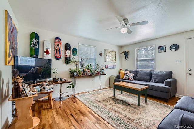 5424 Saulsbury Ct, Arvada, CO 80002 - living room with a ceiling fan, plenty of natural light, wood finished floors, and baseboards