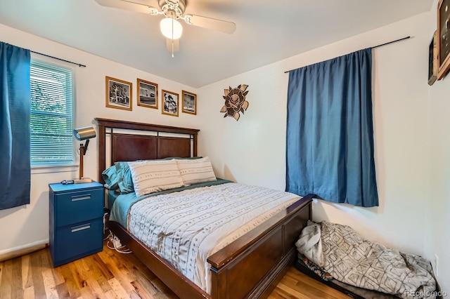 5424 Saulsbury Ct, Arvada, CO 80002 - bedroom with wood finished floors, a ceiling fan, and baseboards