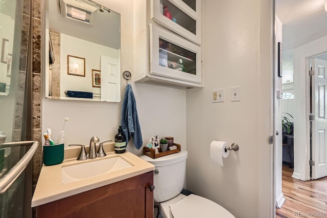 5424 Saulsbury Ct, Arvada, CO 80002 - bathroom with toilet, vanity, and wood finished floors