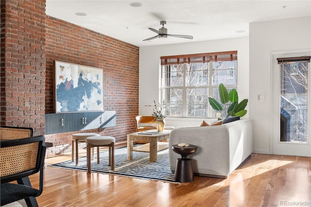 425 S Reed St, Lakewood, CO 80226 - sitting room featuring wood finished floors, a ceiling fan, brick wall, and baseboards