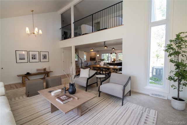 7600 S Ulster Ct, Centennial, CO 80112 - living area featuring high vaulted ceiling, a chandelier, stairway, and baseboards