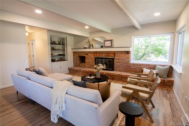 7600 S Ulster Ct, Centennial, CO 80112 - living room featuring wood finished floors, baseboards, beamed ceiling, a brick fireplace, and recessed lighting
