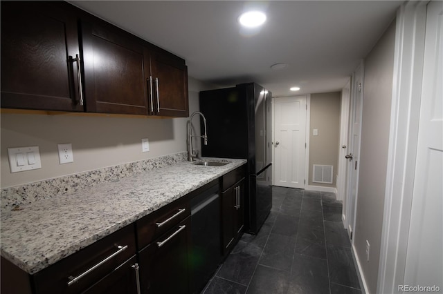 7600 S Ulster Ct, Centennial, CO 80112 - kitchen with freestanding refrigerator, dark brown cabinets, recessed lighting, a sink, and light stone countertops
