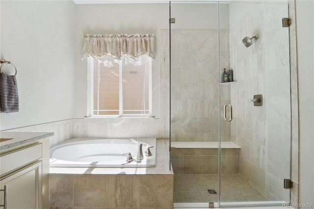 bathroom featuring vanity and separate shower and tub