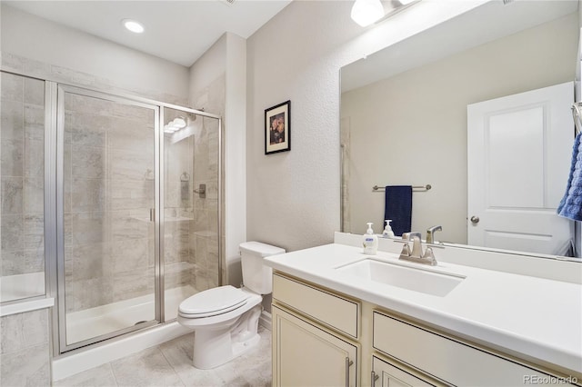 bathroom with tile patterned floors, vanity, toilet, and a shower with shower door