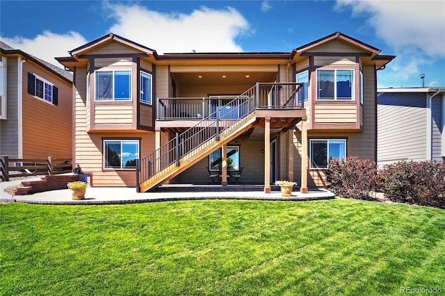 back of house featuring a patio area and a lawn