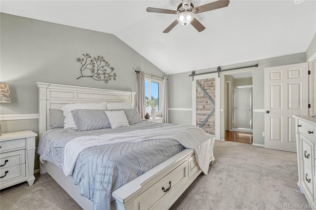 carpeted bedroom with lofted ceiling, a barn door, and ceiling fan