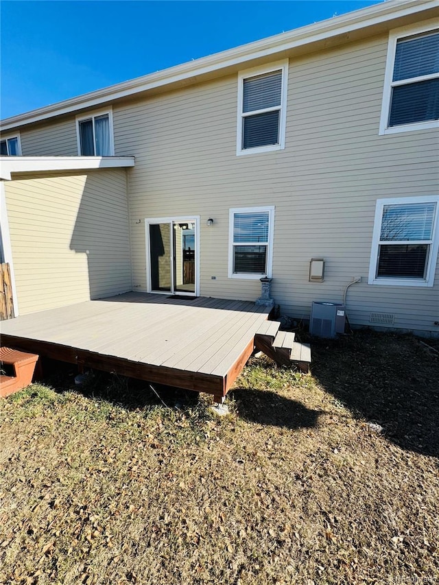 back of property featuring central AC unit and a deck