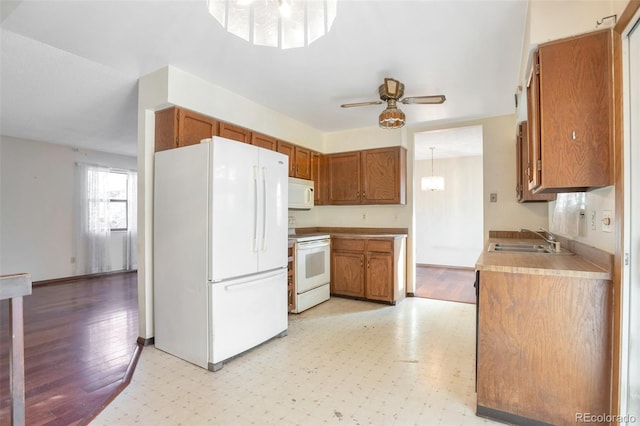 kitchen with ceiling fan, white appliances, and sink