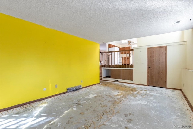 empty room with concrete flooring and a textured ceiling