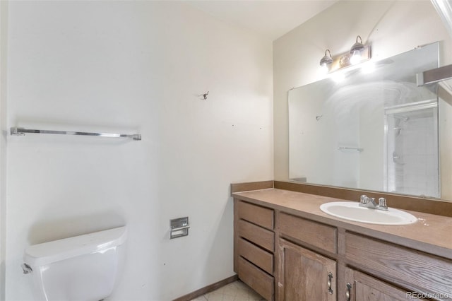 bathroom featuring vanity, a shower, and toilet