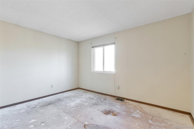 spare room featuring a textured ceiling