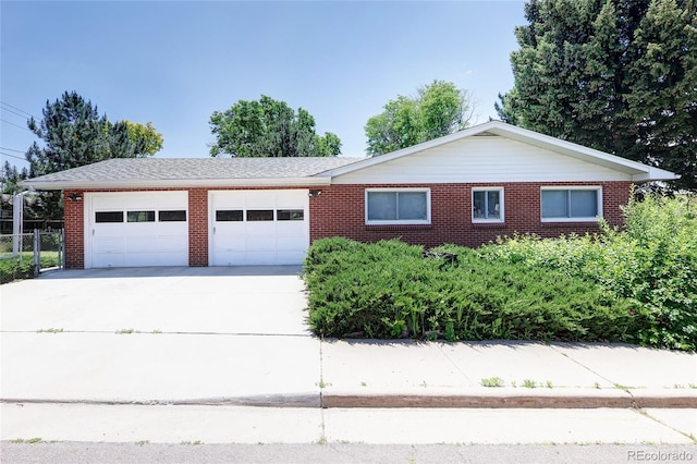 2900 S Golden Way, Denver, CO 80227 - single story home featuring concrete driveway, a garage, and brick siding