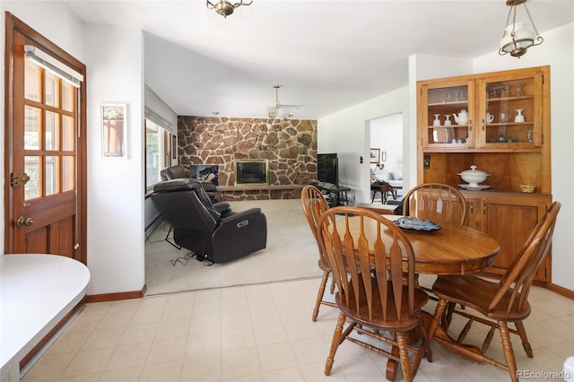 2900 S Golden Way, Denver, CO 80227 - dining area with a fireplace, a baseboard heating unit, and light colored carpet
