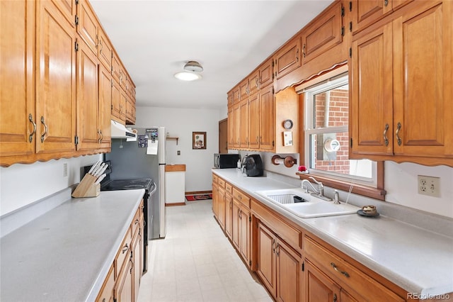 2900 S Golden Way, Denver, CO 80227 - kitchen featuring under cabinet range hood, range with electric cooktop, light countertops, brown cabinetry, and light floors