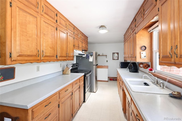 2900 S Golden Way, Denver, CO 80227 - kitchen featuring under cabinet range hood, stainless steel range with electric cooktop, light flooring, light countertops, and brown cabinetry