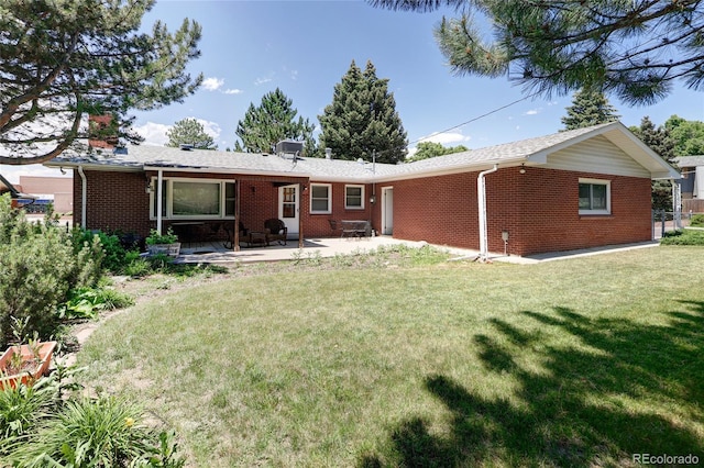 2900 S Golden Way, Denver, CO 80227 - back of house with brick siding, a yard, a patio area, and a chimney