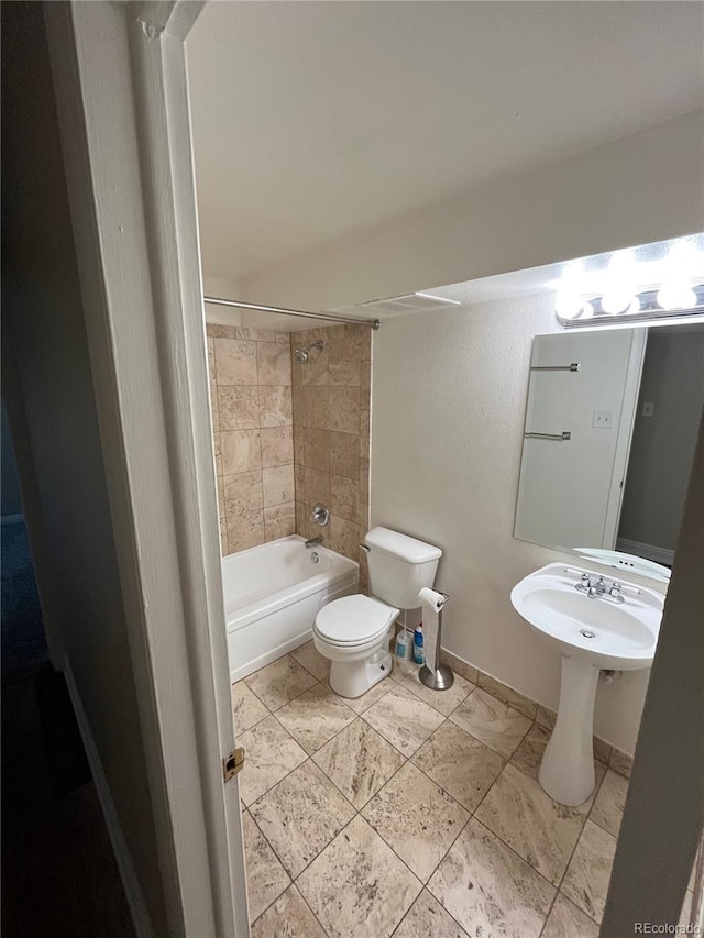 full bathroom featuring shower / bath combination, baseboards, and toilet