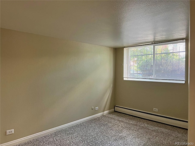 carpeted spare room with baseboards, a baseboard radiator, and a textured ceiling