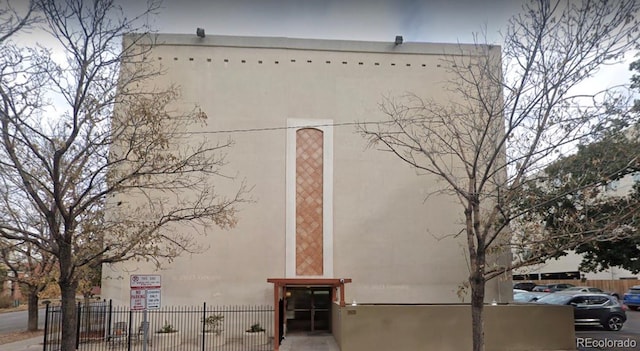 exterior space with fence and stucco siding