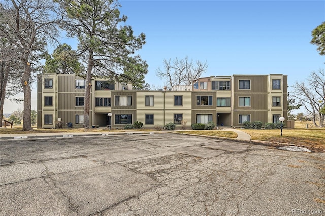 view of building exterior with uncovered parking